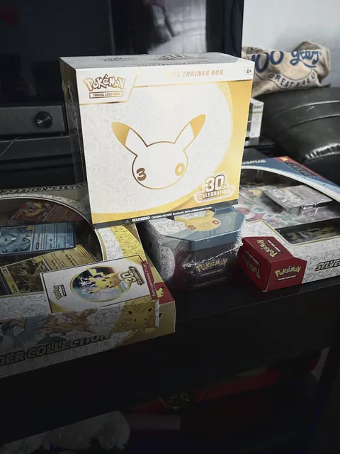A Pokémon 30th Celebration Elite Trainer Box on a shelf with the rest of a drop-day haul